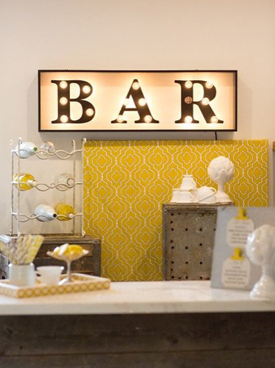 Stylish home bar decor with illuminated BAR sign and accents