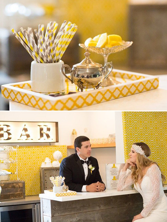 Wedding bar setup with yellow decor and bride and groom