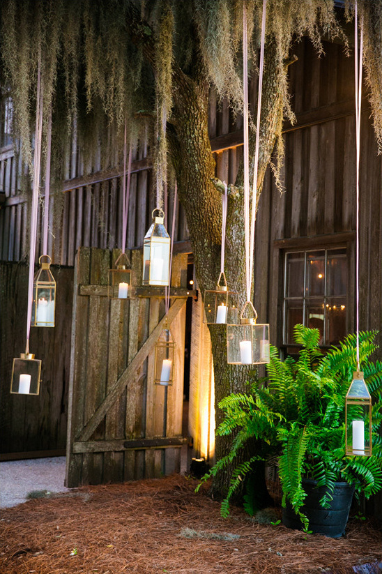 Rustic barn entrance with hanging lanterns and candles