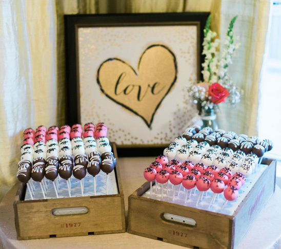 Delicious cake pops at a wedding reception dessert table