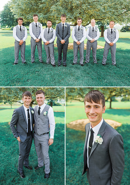 Groomsmen in gray suits posing outdoors for wedding photos