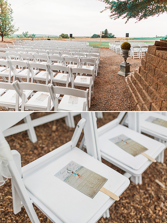 Outdoor wedding ceremony with white chairs and programs