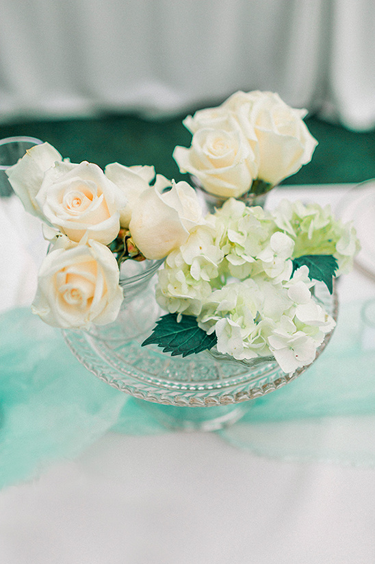 Elegant roses and hydrangeas centerpiece on glass stand