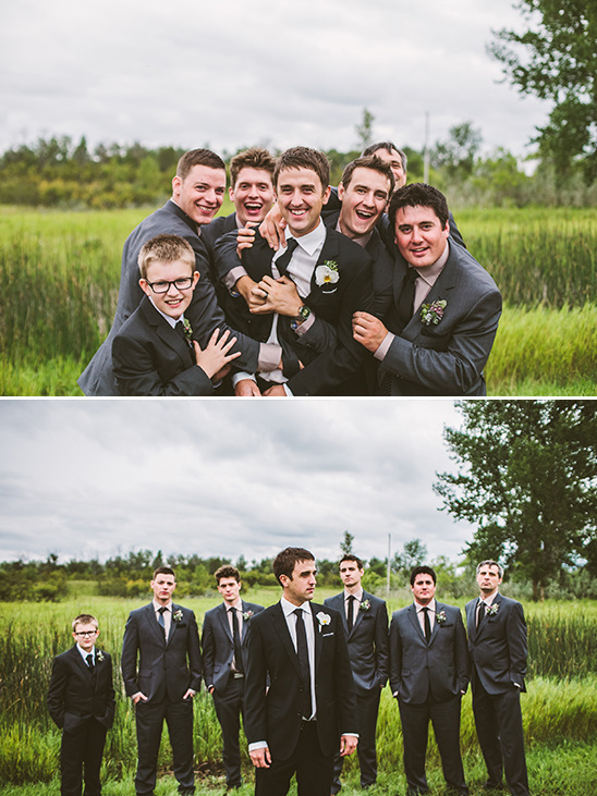 Groom and groomsmen posing in a grassy field wedding party