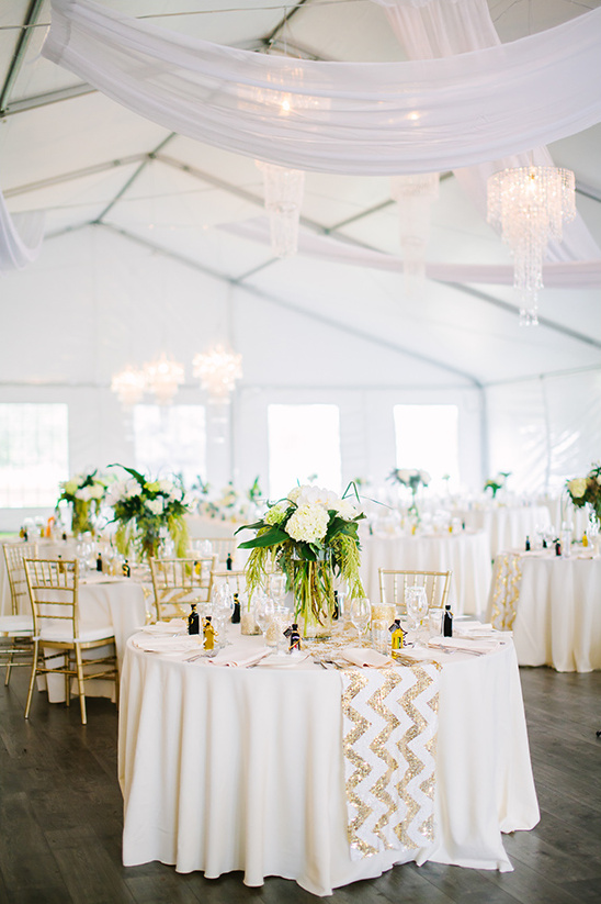 Elegant tented wedding reception with gold accents