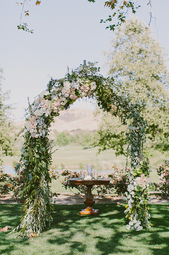 floral wedding ceremony arch @weddingchicks