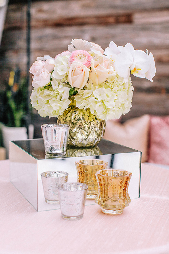 Elegant pink and white floral centerpiece with gold votives