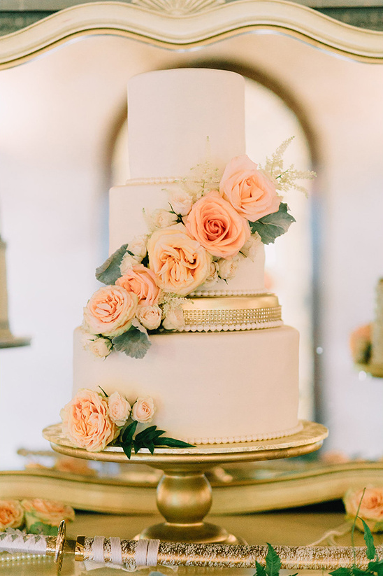 elegant flower accented wedding cake @weddingchicks