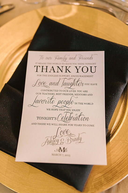 Wedding thank you card on gold charger and black napkin