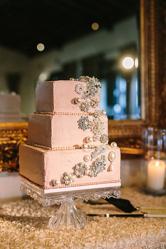 Elegant pink wedding cake with pearl and jeweled accents