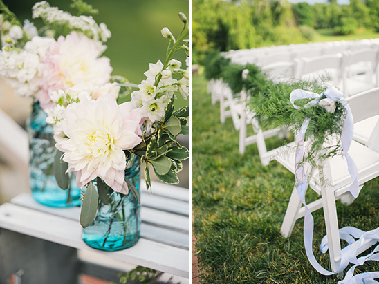 Flowers in jars and decorated chairs for wedding ceremony