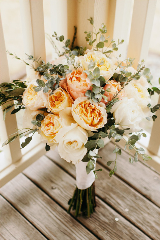 Elegant peach and cream rose wedding bouquet close up