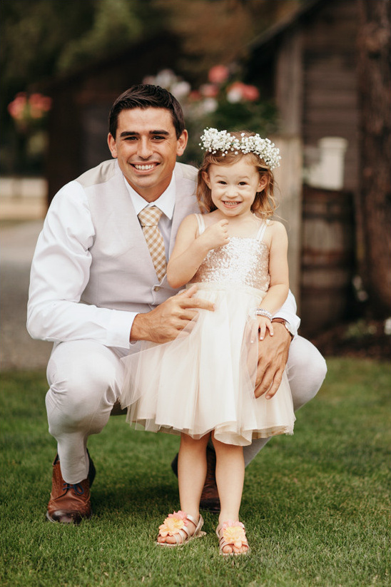 Man and girl in flower crown at a wedding reception