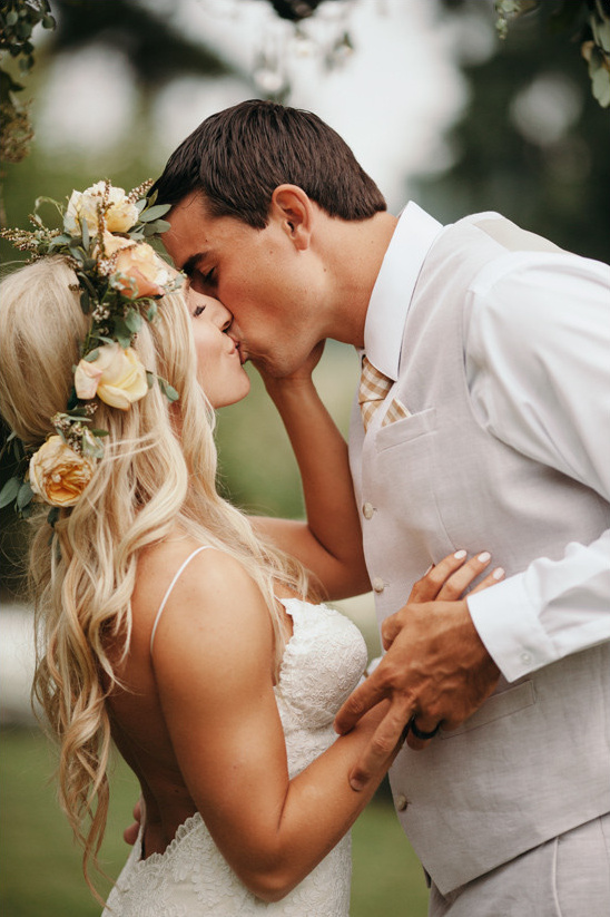 Bride and groom sharing a tender kiss at their wedding