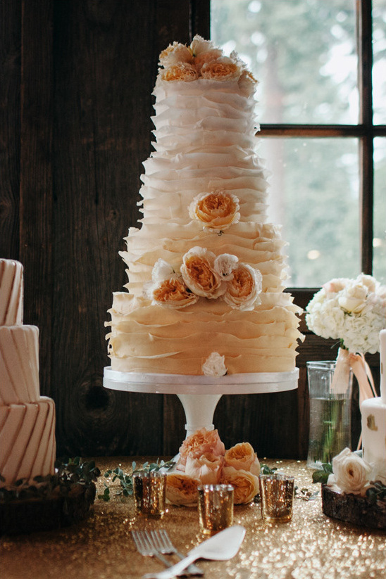 Elegant buttercream ruffled wedding cake with fresh flowers