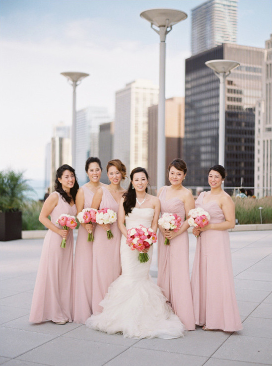 Bride and bridesmaids in pink dresses with bouquets