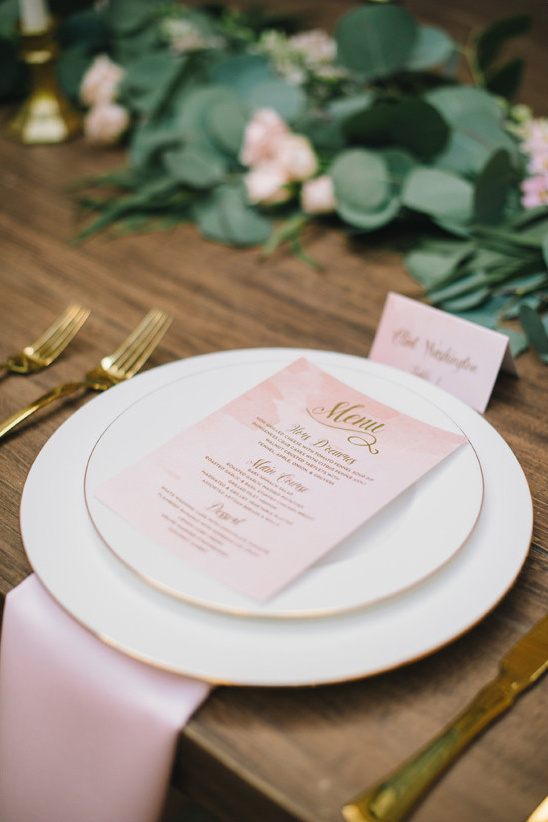Elegant wedding place setting with menu and gold cutlery