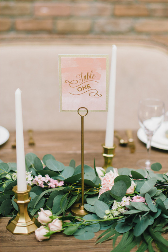 Table one decoration with candles and floral garland