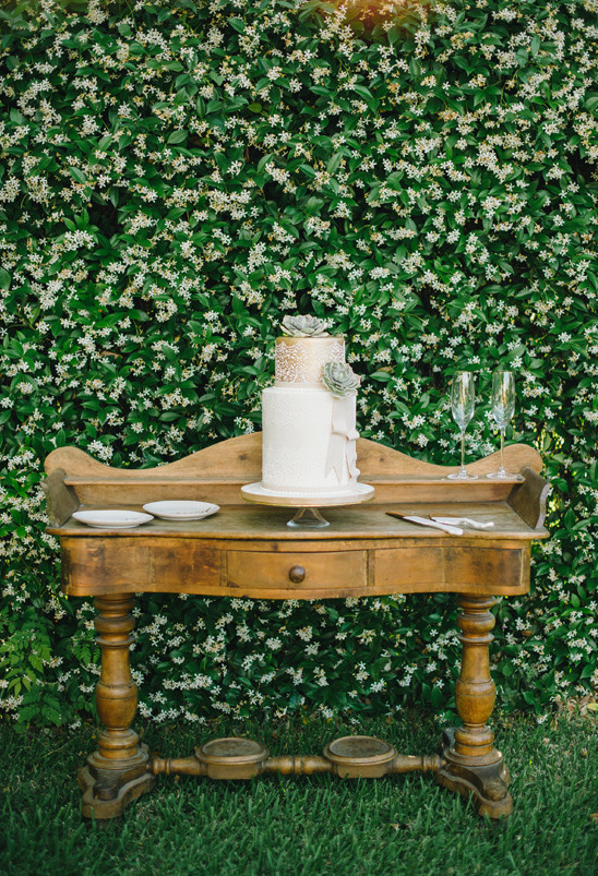 Wedding cake on wooden table with floral background