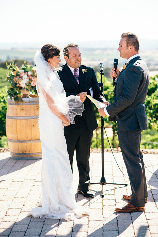 Bride and groom exchanging vows at outdoor wedding