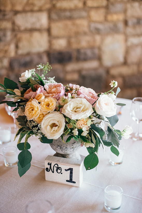 Table number one with floral centerpiece at wedding reception
