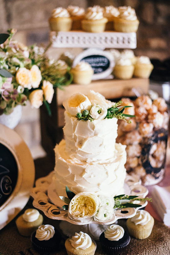 Rustic wedding cake and cupcake dessert display