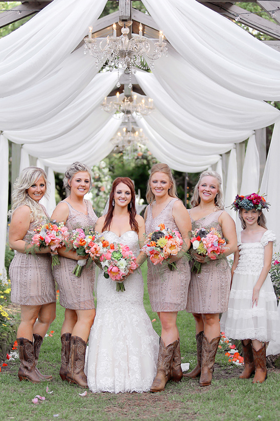 Bride and bridesmaids in boots at outdoor wedding venue