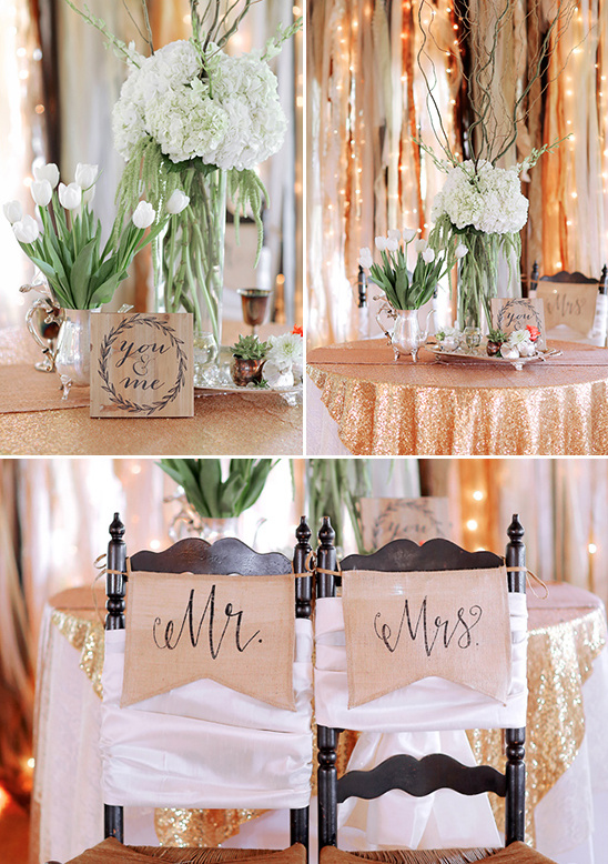 Rustic wedding decor with floral arrangements and Mr & Mrs chairs