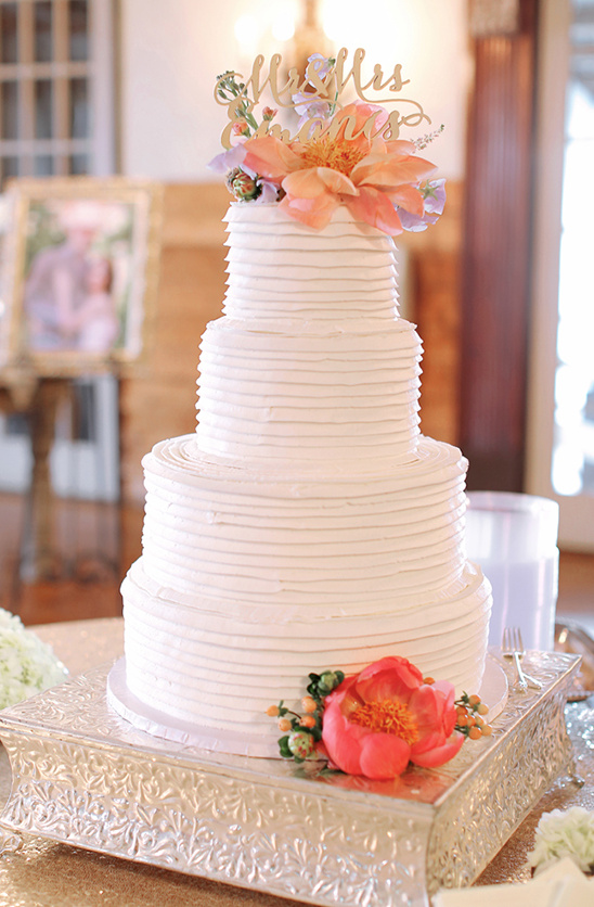 Elegant four-tiered wedding cake with flowers