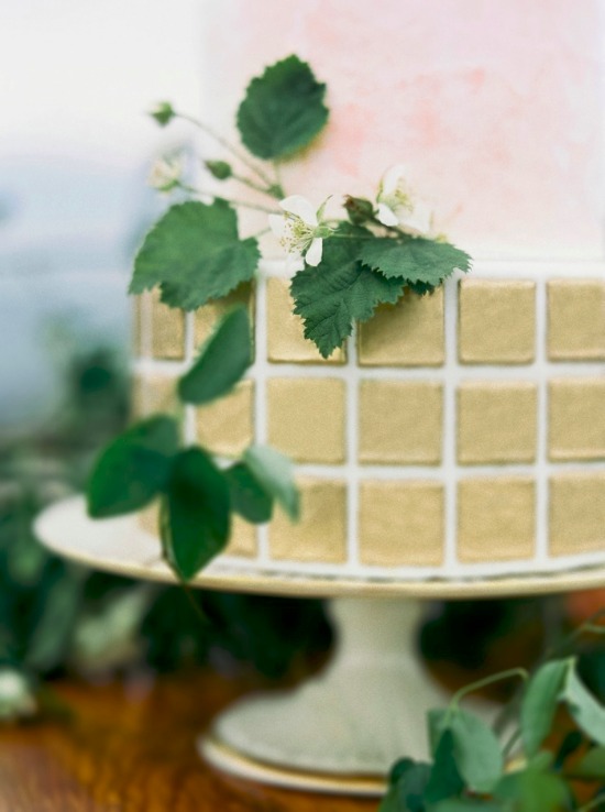Elegant wedding cake with gold tiles and floral accents