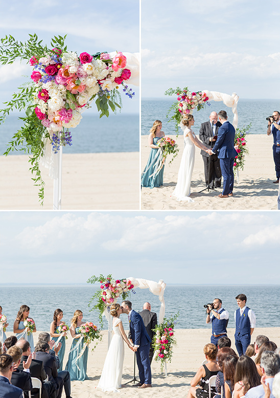Beach wedding ceremony with floral arch and ocean view