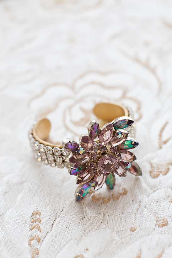 Rhinestone cuff bracelet with a pink floral embellishment