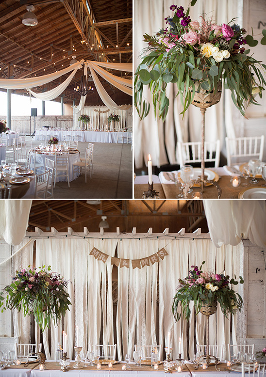 Rustic barn wedding reception decor with floral arrangements