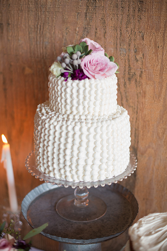 Two tier wedding cake with roses and textured frosting