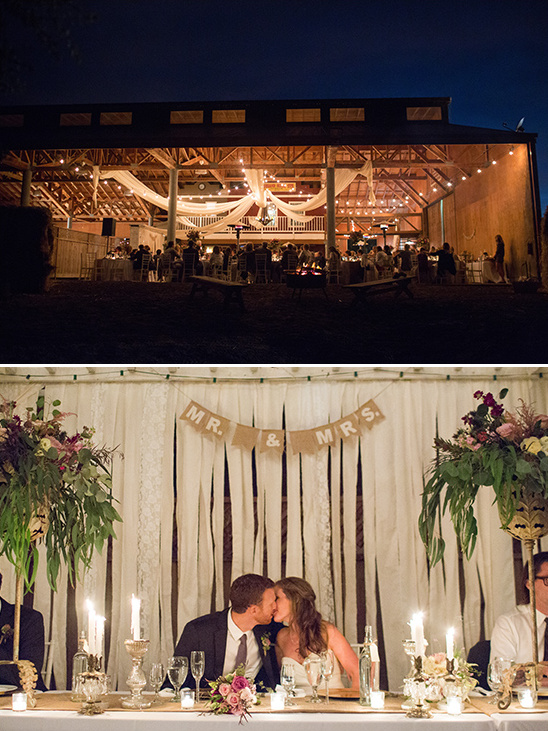 Rustic barn wedding reception at night kissing couple