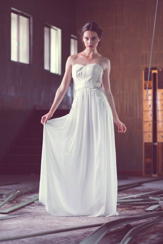 Woman in white strapless dress in industrial space