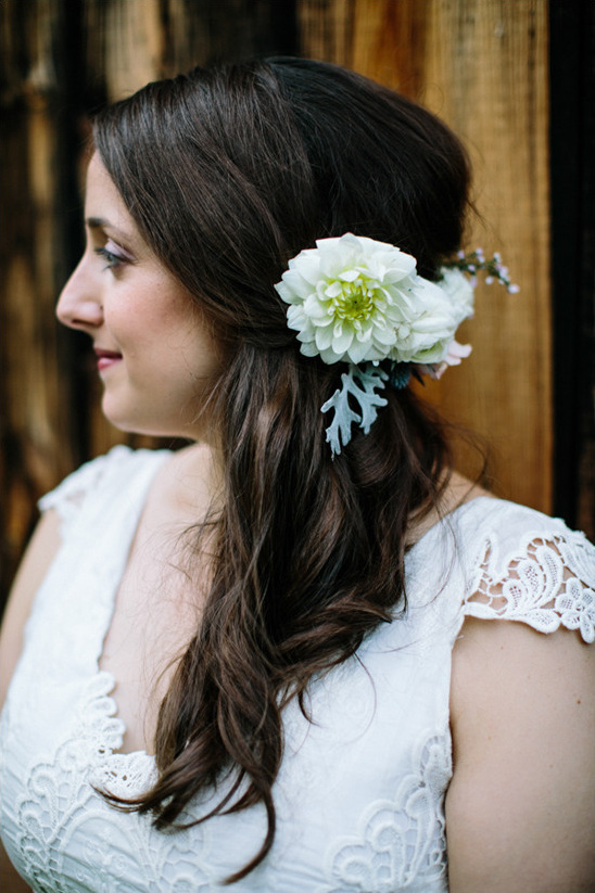Bride with elegant side hairstyle and white flower