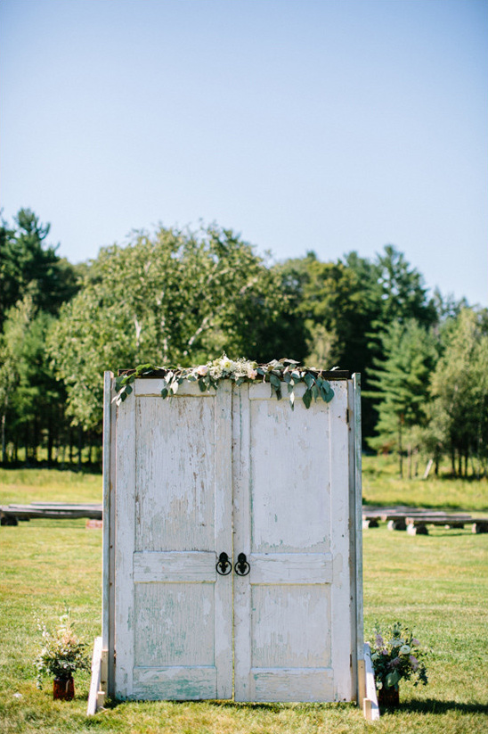 Rustic outdoor wedding altar with repurposed doors