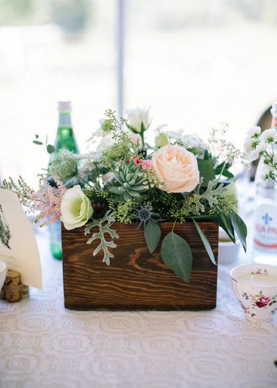 Rustic wooden box filled with romantic floral arrangement