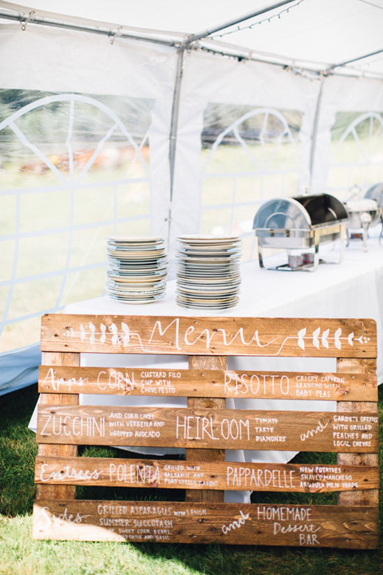 Rustic wedding buffet featuring a pallet menu sign