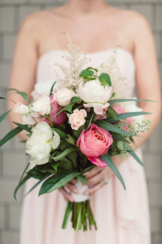Bridesmaid holding a bouquet of pink and white flowers
