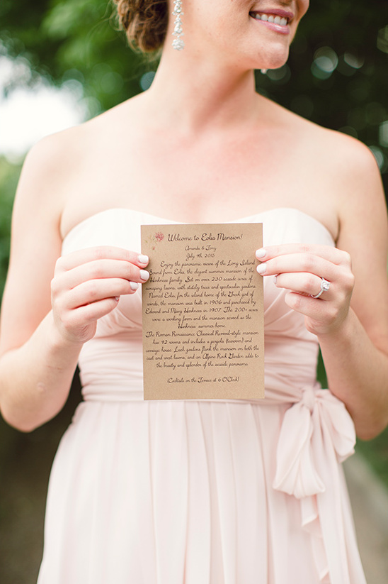 Bridesmaid holding wedding invitation to the Edsel Mansion