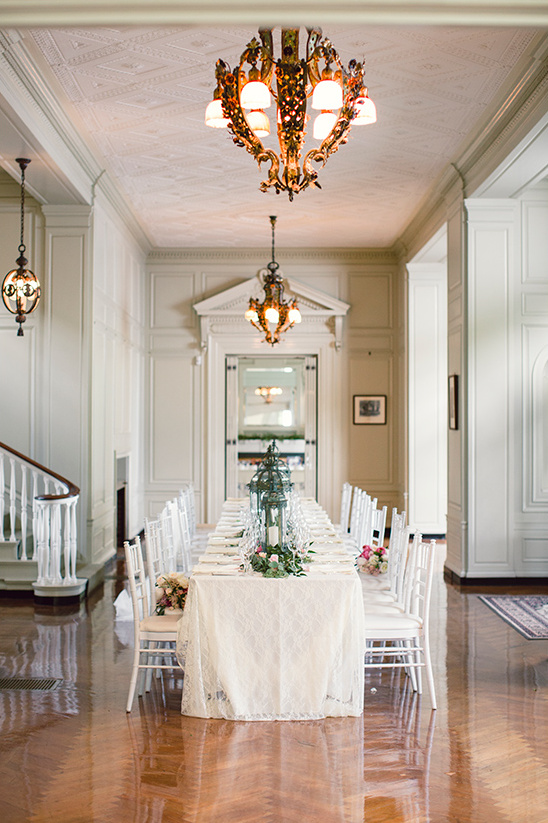 Elegant dining room with long table and chandeliers
