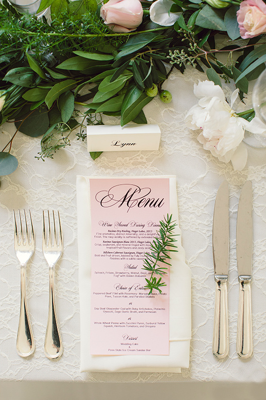 Elegant wedding table setting with menu and floral decor
