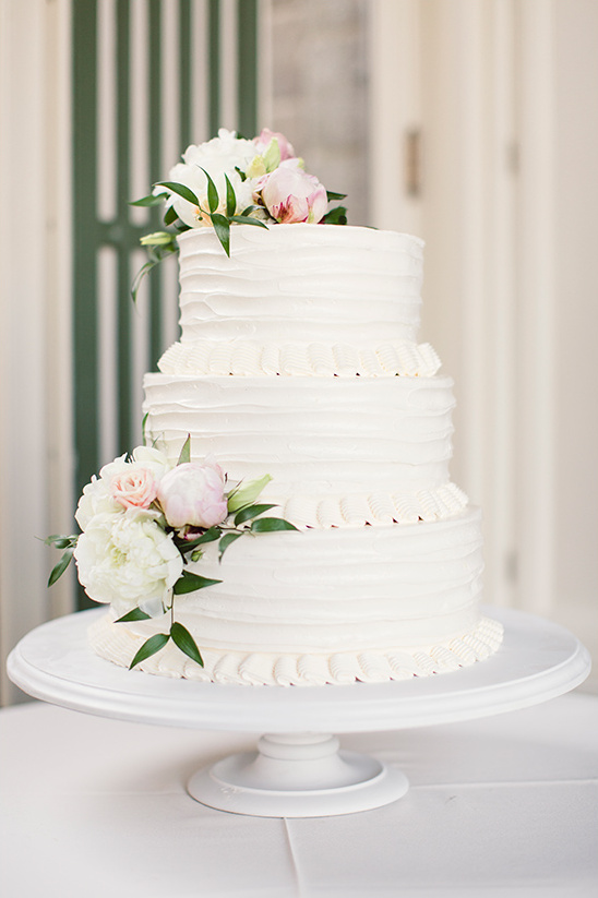Elegant three tier wedding cake with floral accents