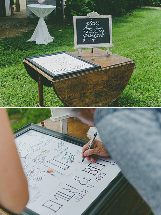 Wedding guest book signing station at outdoor reception