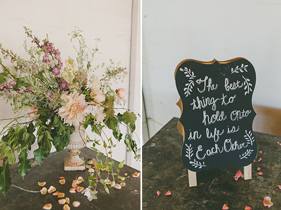Floral centerpiece and wedding sign saying each other