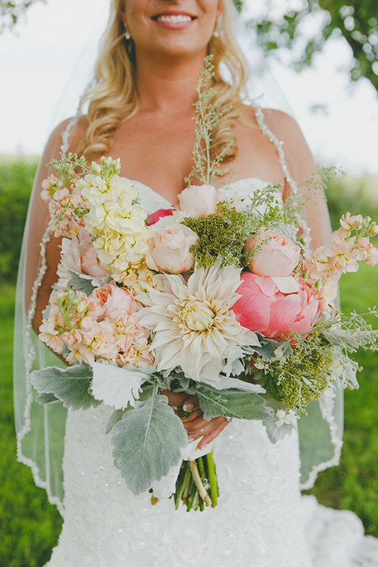 Bride holding a colorful wedding bouquet of flowers