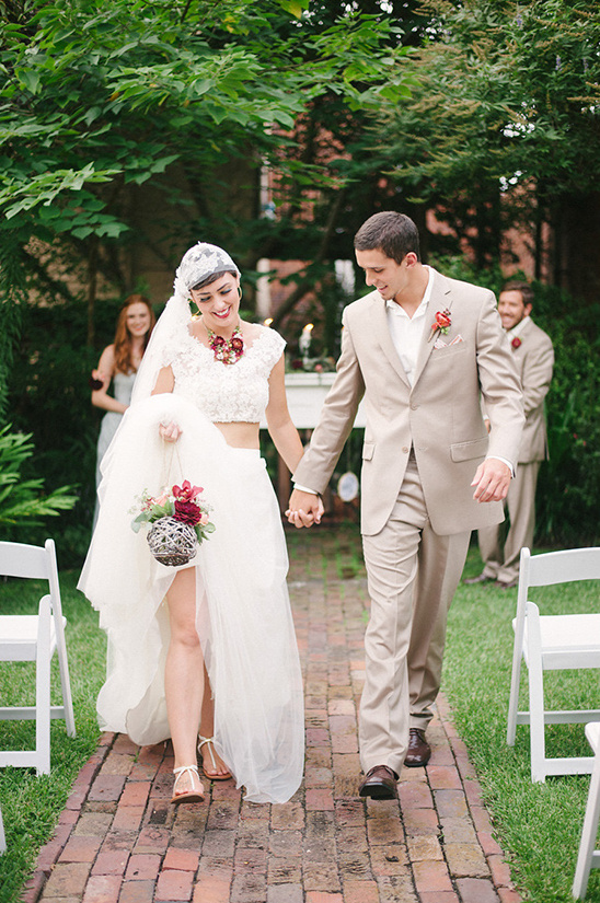 Happy couple walking down the aisle after outdoor wedding ceremony