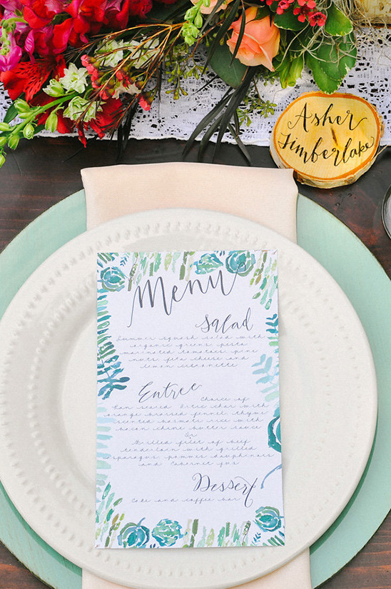 Wedding menu with watercolor design on a white plate